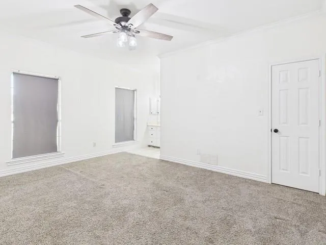 an empty room with fan and a ceiling fan