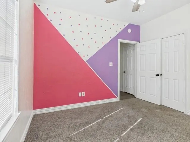 a very nice looking room with a ceiling fan