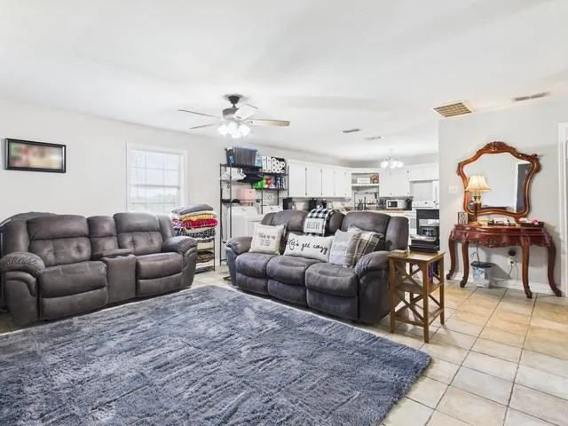 a living room with furniture a dining table and a piano