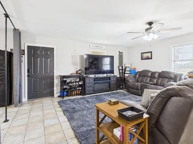 a living room with furniture and a flat screen tv