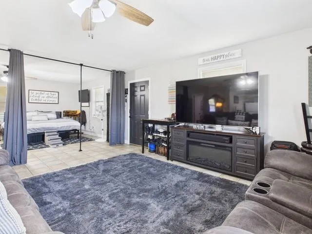 a living room with furniture and a flat screen tv