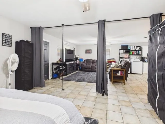 a bedroom with furniture and a mirror