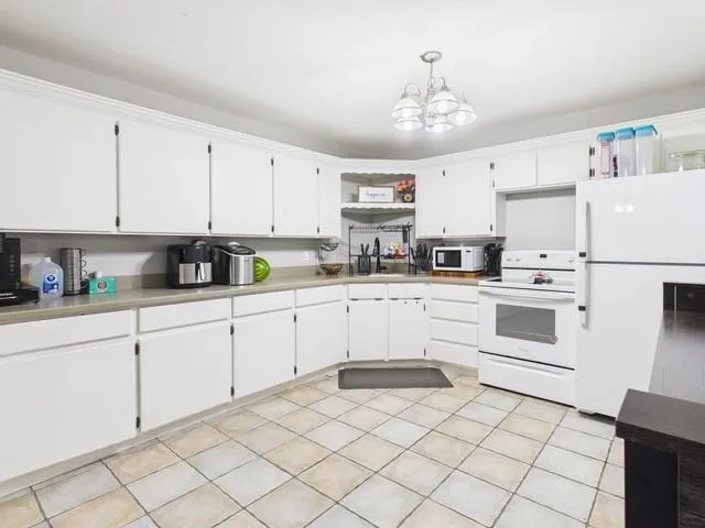 a kitchen with white cabinets stainless steel appliances and sink