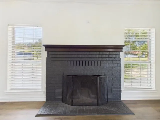 a living room with a fireplace and a table
