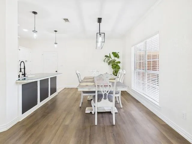 a dining room with furniture and wooden floor