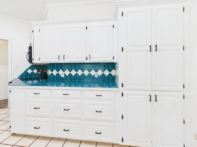 a view of white cabinet with two white cabinets