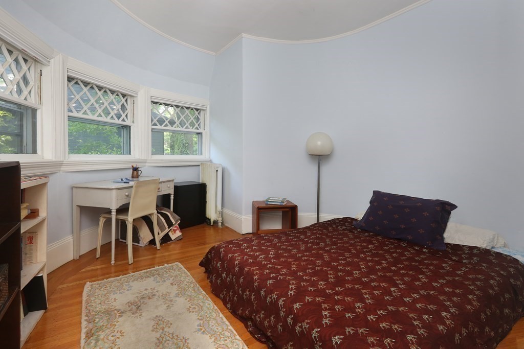 53 Brington Road Brookline, MA 02445 - Photo 9 of 12 a bedroom with furniture and a fireplace