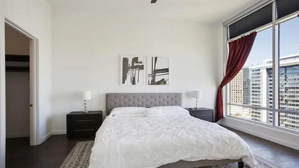 a bedroom with a large bed and a window