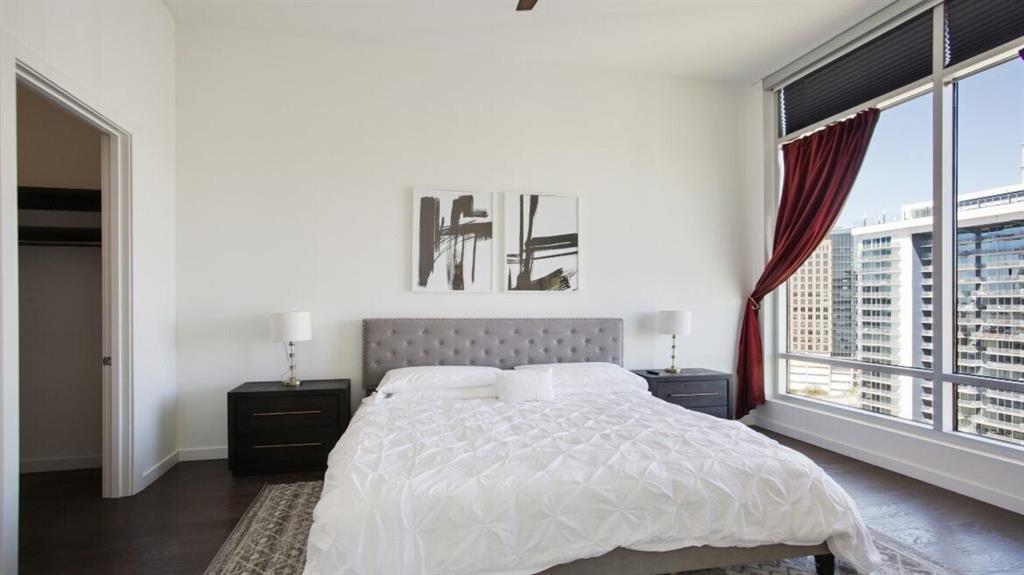 205 12th Street Northeast, Unit 2005 Atlanta, GA 30309 - Photo 12 of 25 a bedroom with a bed and a large window