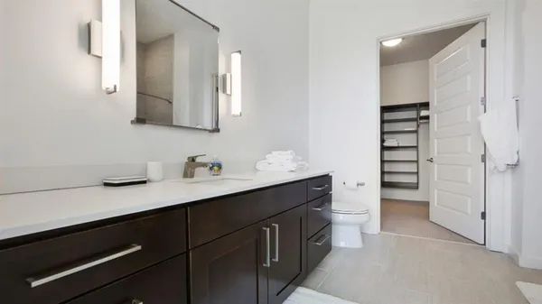 a view of walk in closet with empty racks