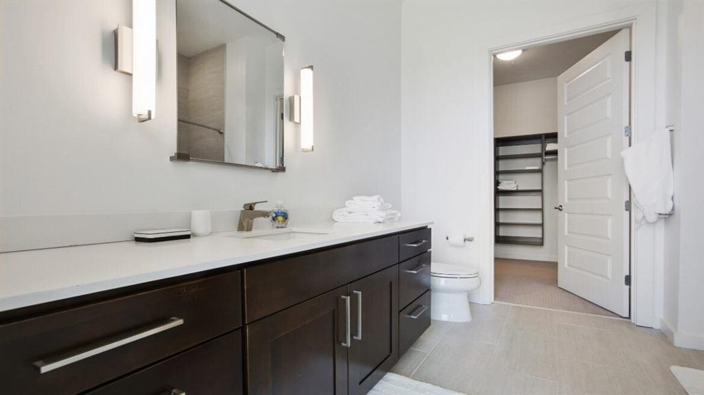 205 12th Street Northeast, Unit 2005 Atlanta, GA 30309 - Photo 16 of 25 a bathroom with a double vanity sink and mirror