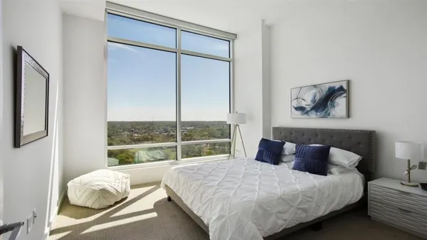 a bedroom with a bed and a flat tv screen