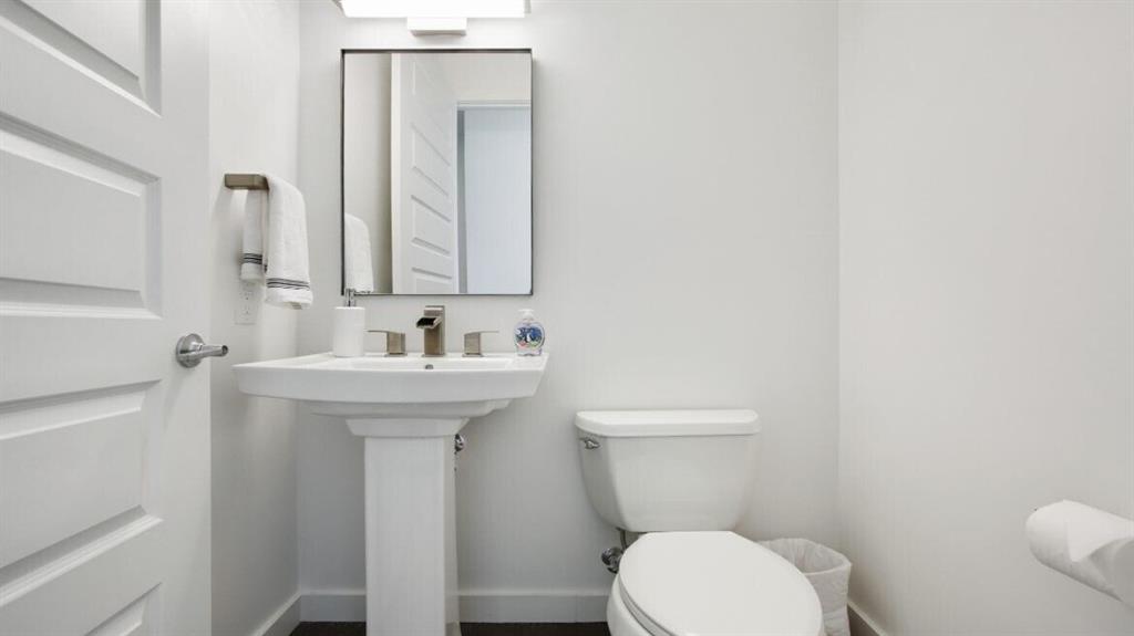 205 12th Street Northeast, Unit 2005 Atlanta, GA 30309 - Photo 22 of 25 a bathroom with a sink a toilet and mirror
