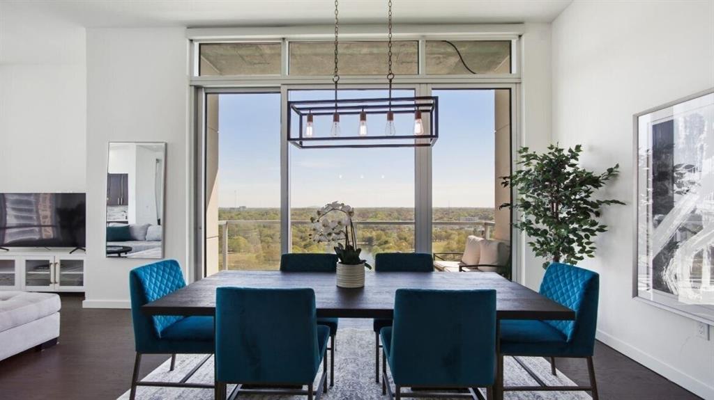 205 12th Street Northeast, Unit 2005 Atlanta, GA 30309 - Photo 6 of 25 a view of a dining room with furniture window and wooden floor