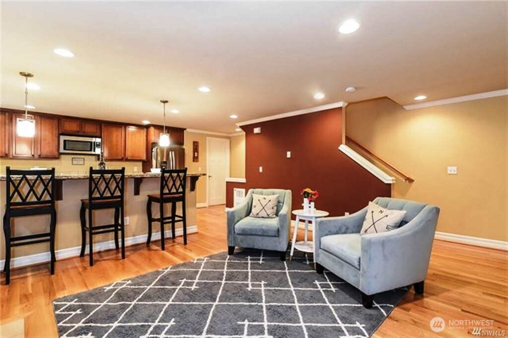 725 North 95th Street, Unit C Seattle, WA 98103 - Photo 4 of 18 a living room with furniture and kitchen view