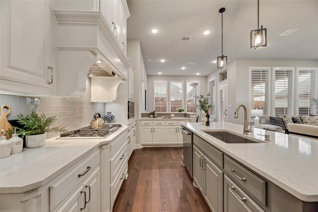 2425 Eclipse Place Celina, TX 75009 - Photo 10 of 40 a kitchen with a sink stove and cabinets