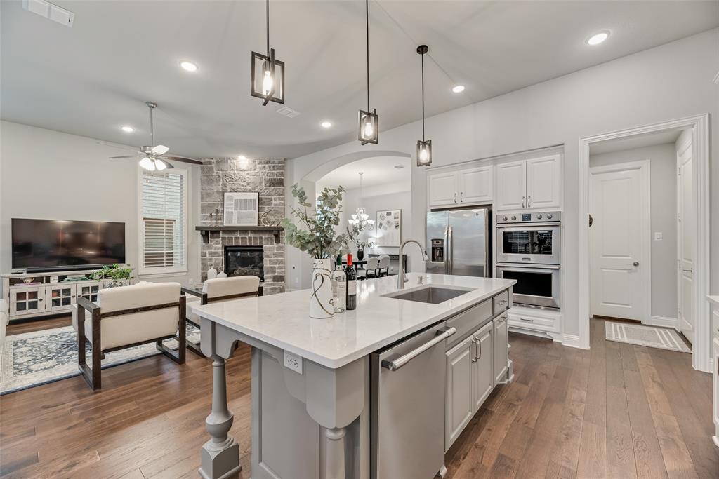 2425 Eclipse Place Celina, TX 75009 - Photo 11 of 40 a large kitchen with kitchen island a sink table and chairs