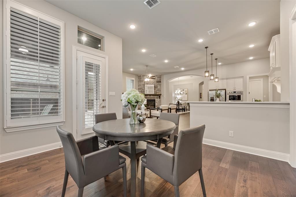 2425 Eclipse Place Celina, TX 75009 - Photo 12 of 40 a dining room with kitchen island furniture a large window and wooden floor