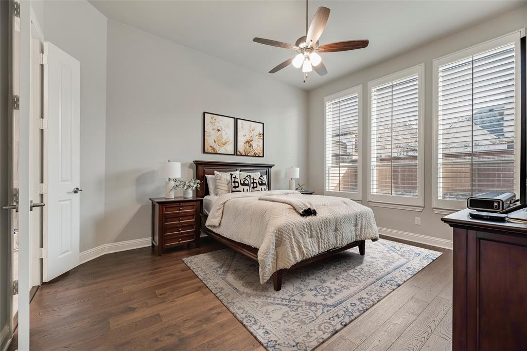 2425 Eclipse Place Celina, TX 75009 - Photo 16 of 40 a bedroom with a bed and a chandelier