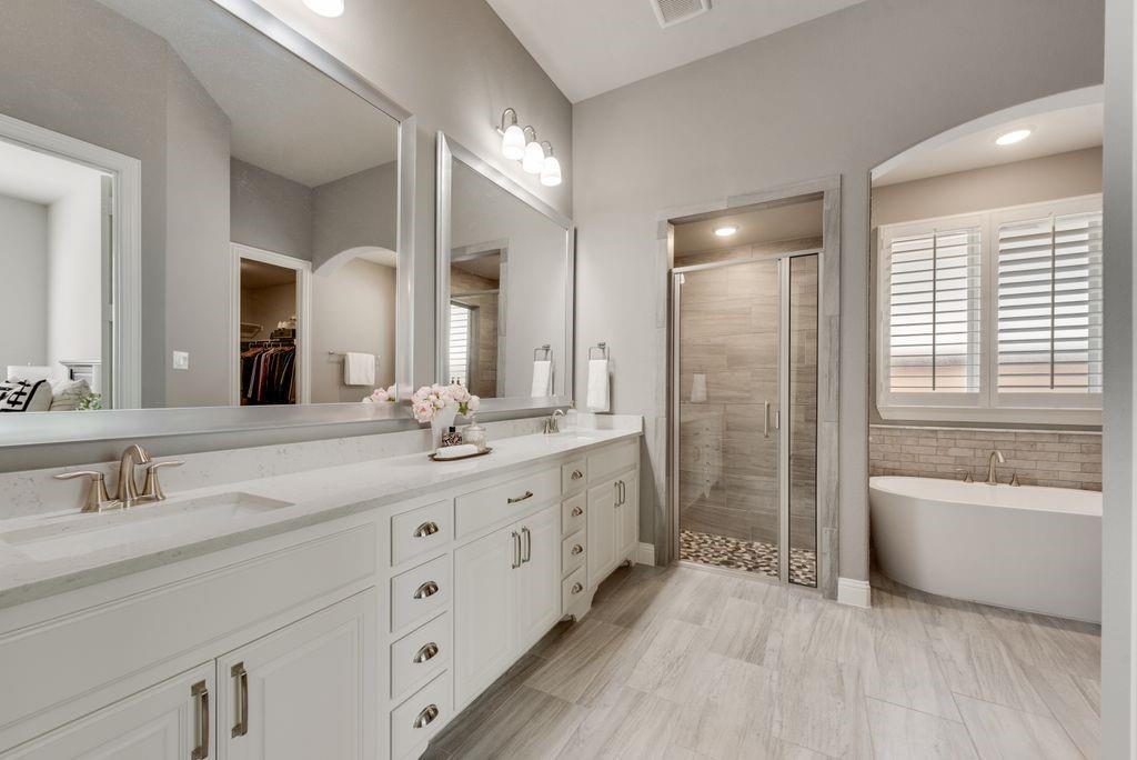 2425 Eclipse Place Celina, TX 75009 - Photo 18 of 40 a bathroom with double vanity sink a two mirror a window a bathtub and shower