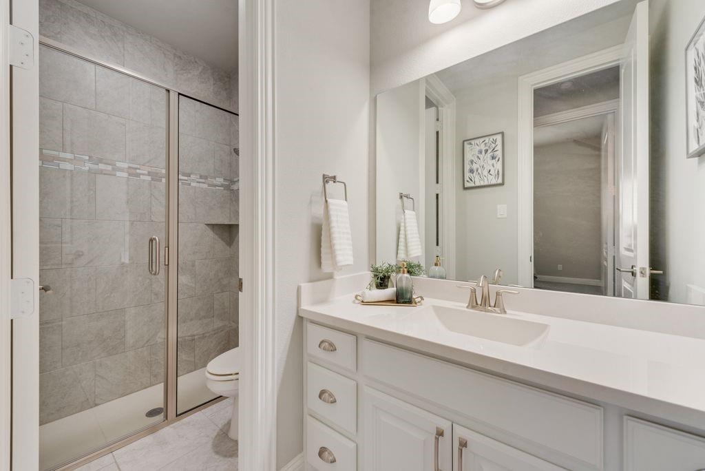 2425 Eclipse Place Celina, TX 75009 - Photo 24 of 40 a bathroom with a shower sink and mirror