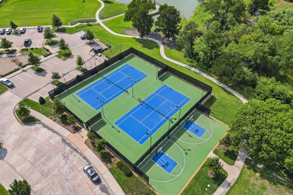 2425 Eclipse Place Celina, TX 75009 - Photo 35 of 40 an aerial view of a tennis ground with a large pool