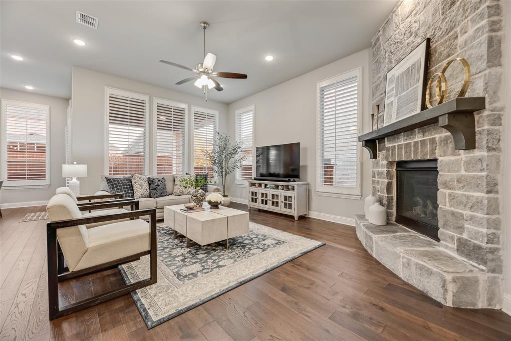 2425 Eclipse Place Celina, TX 75009 - Photo 5 of 40 a living room with furniture a flat screen tv and a fireplace