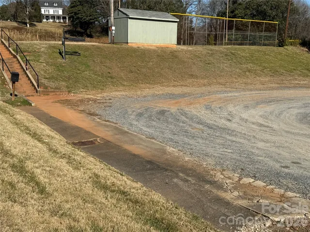 a view of a yard with basketball court