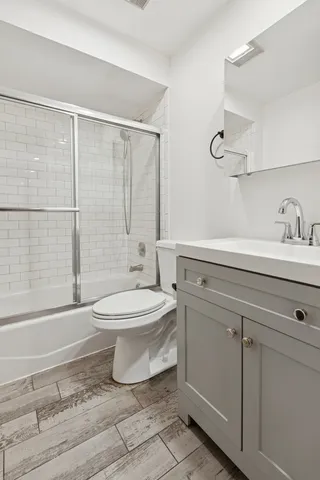 a bathroom with a toilet sink and shower