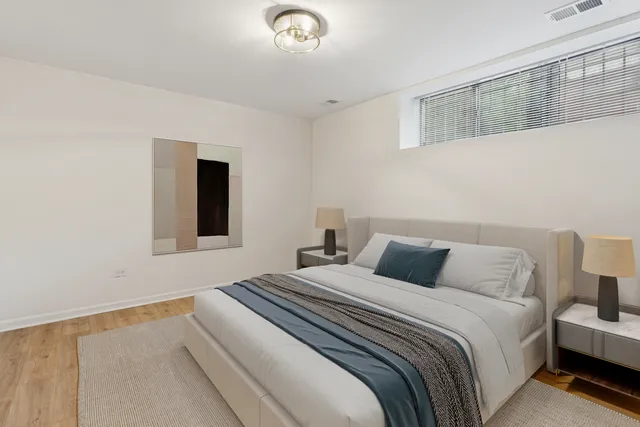 a bedroom with a bed and a night stand