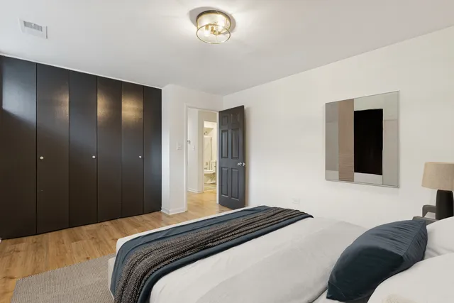 a bedroom with a bed and a chandelier