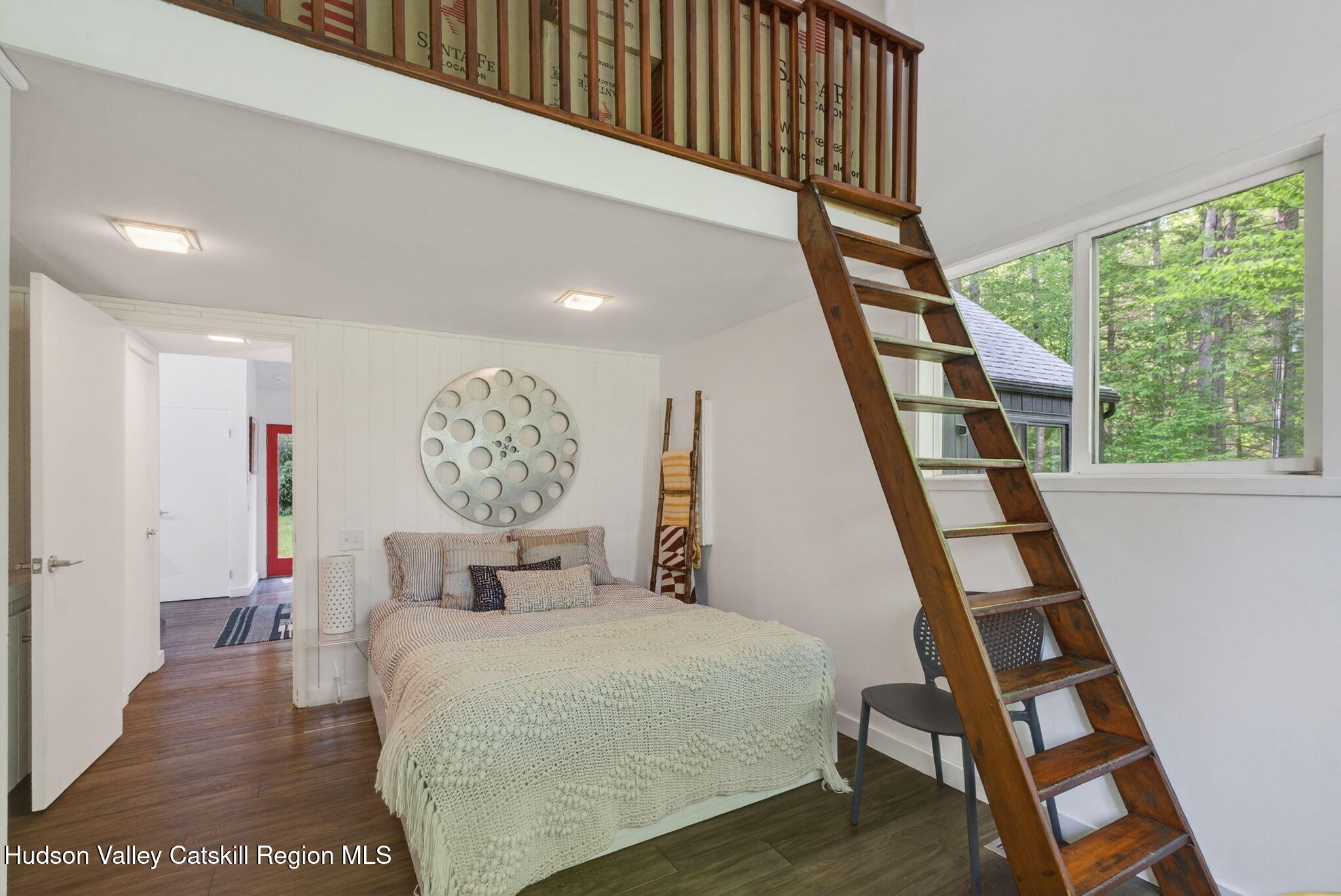 69 Irondale Road Phoenicia, NY 12464 - Photo 23 of 30 a bedroom with a bed and wooden floor