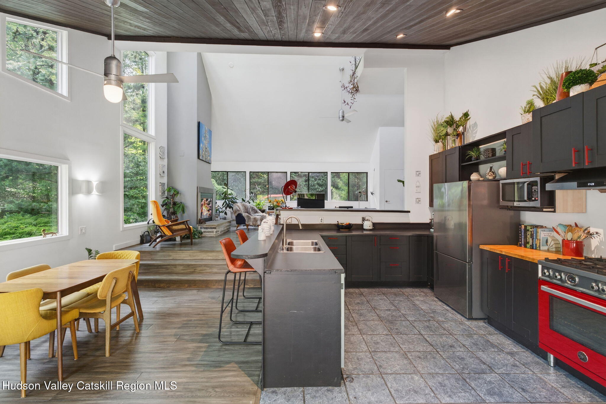 69 Irondale Road Phoenicia, NY 12464 - Photo 10 of 30 a kitchen with stainless steel appliances kitchen island granite countertop a table chairs and a refrigerator