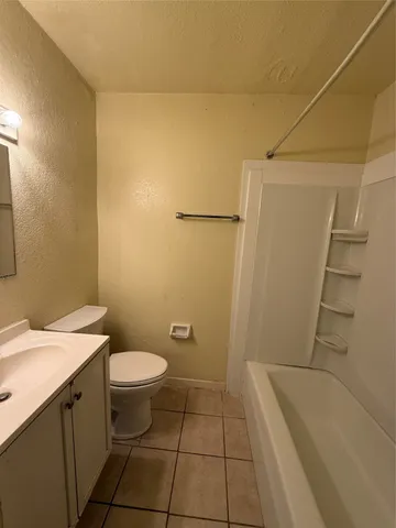 a bathroom with a shower and a bath tub