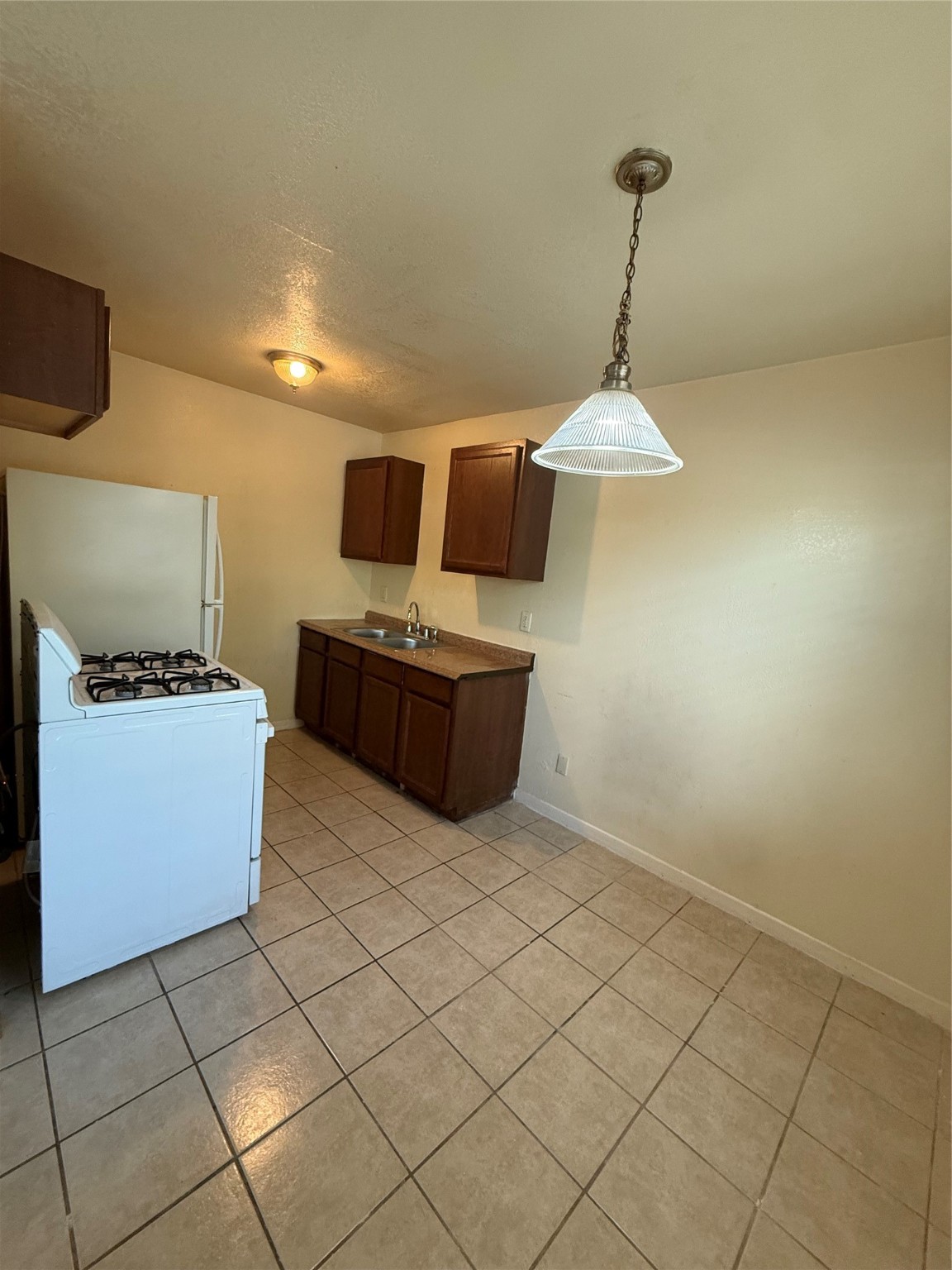3502 Campbell Street, Unit 2 Houston, TX 77026 - Photo 6 of 14 a kitchen with stainless steel appliances a stove a sink and a refrigerator