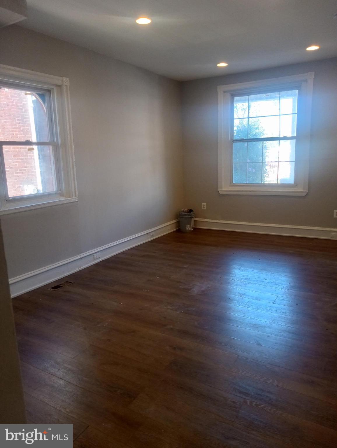 1650 Dyre Street, Unit 1 Philadelphia, PA 19124 - Photo 2 of 9 an empty room with wooden floor and windows
