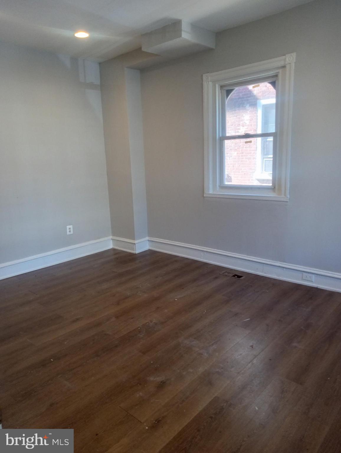 1650 Dyre Street, Unit 1 Philadelphia, PA 19124 - Photo 3 of 9 an empty room with wooden floor and windows