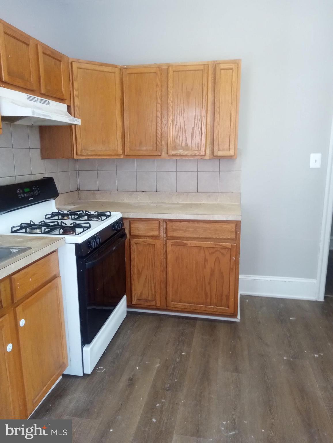 1650 Dyre Street, Unit 1 Philadelphia, PA 19124 - Photo 5 of 9 a kitchen with stainless steel appliances granite countertop a stove a sink and a refrigerator