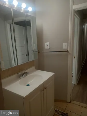 a bathroom with a sink and mirror