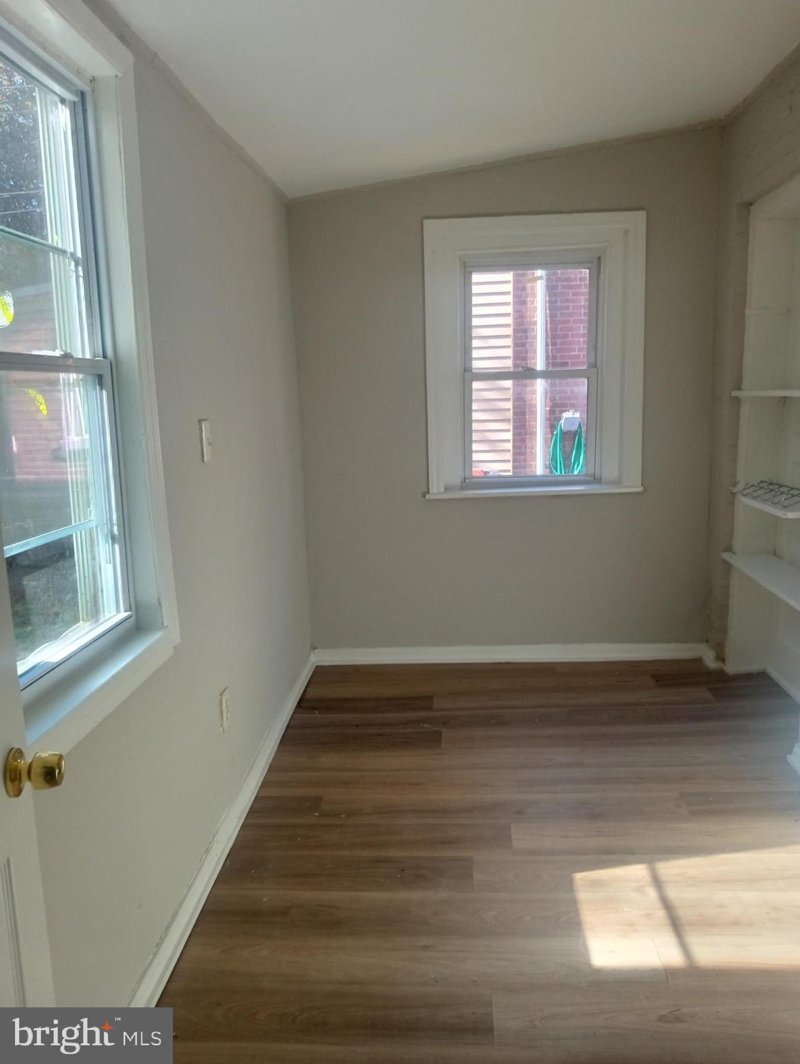 1650 Dyre Street, Unit 1 Philadelphia, PA 19124 - Photo 9 of 9 a view of an empty room with wooden floor and a window