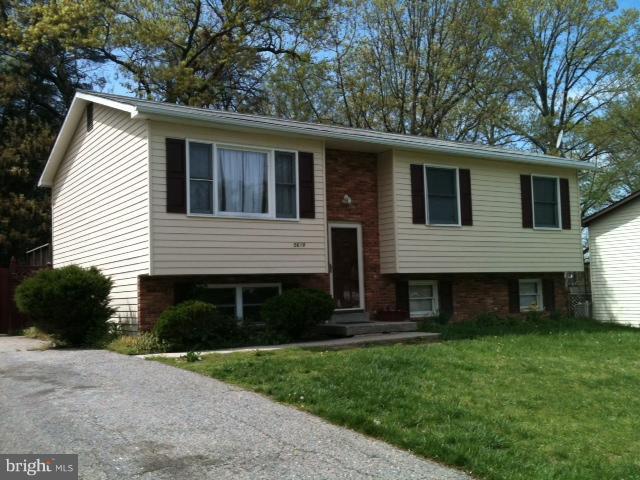 5618 Westgate Road Lanham, MD 20706 - Photo 1 of 17 a front view of a house with a yard and garage