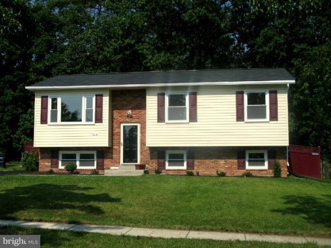 5618 Westgate Road Lanham, MD 20706 - Photo 11 of 17 a front view of a house with a garden