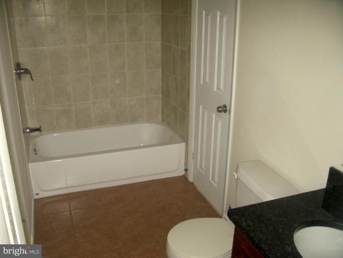 5618 Westgate Road Lanham, MD 20706 - Photo 3 of 17 a bathroom with a sink toilet and shower