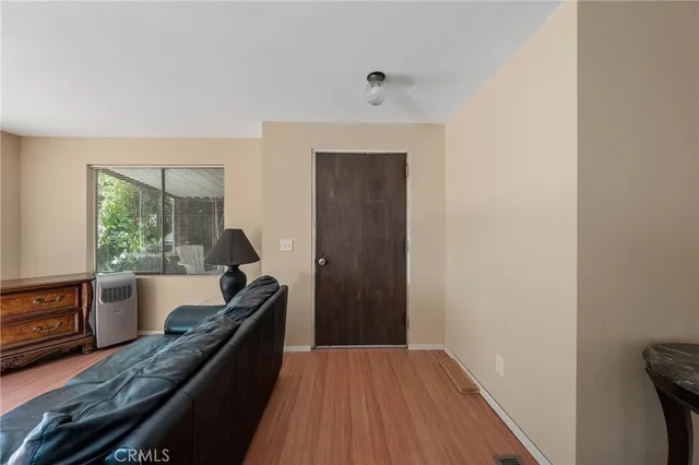 a view of a hallway with furniture and wooden floor