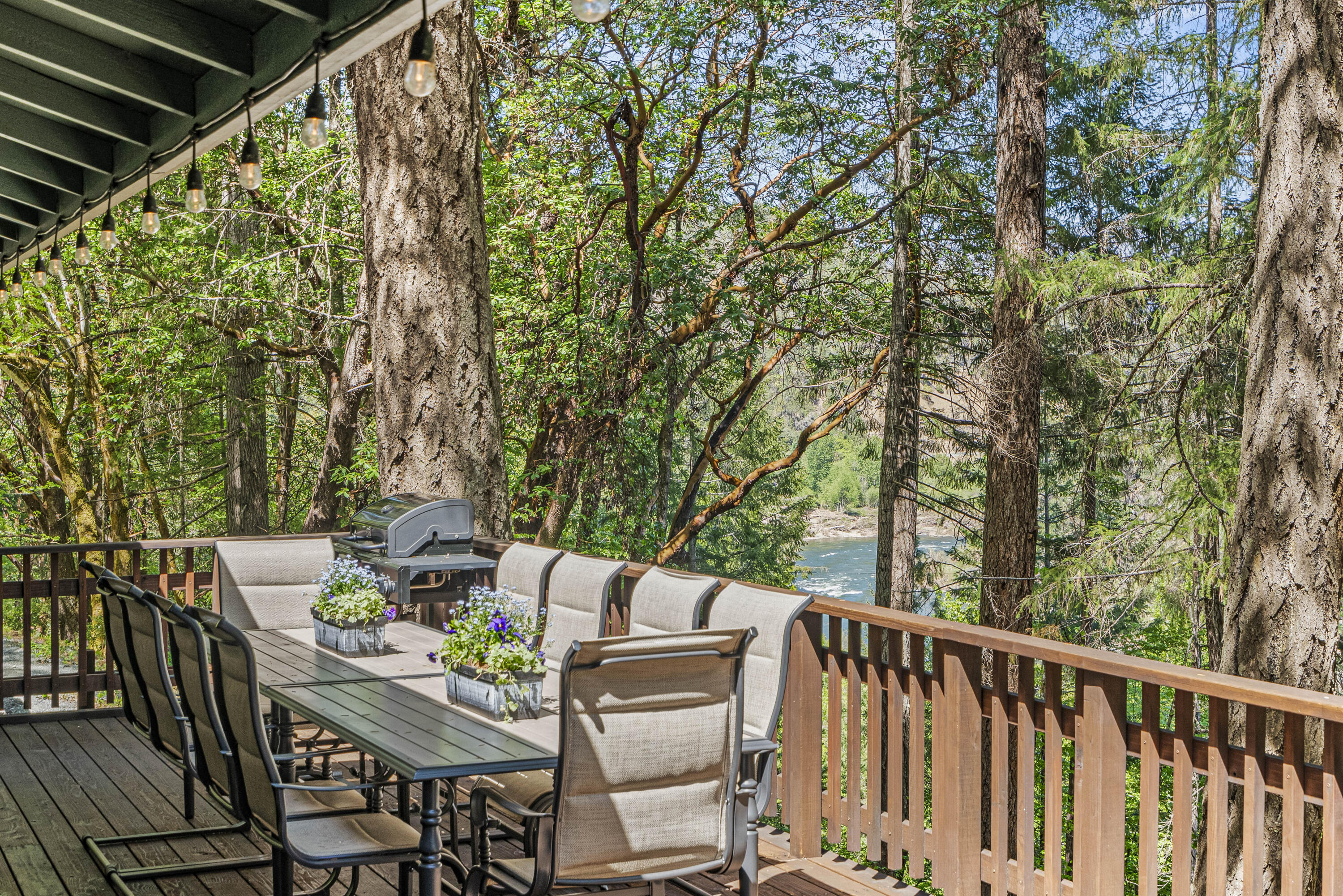 11744 Galice Road Merlin, OR 97532 - Photo 56 of 74 a view of a patio with table and chairs and wooden floor