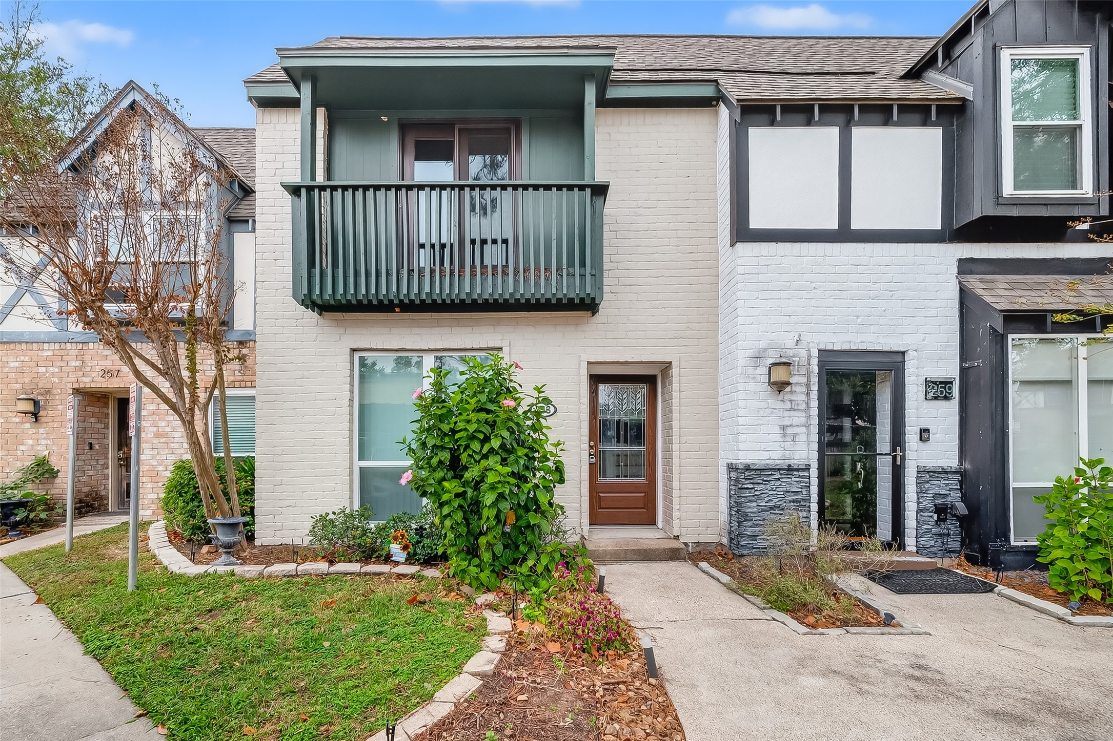 a view of a house with a small yard and plants