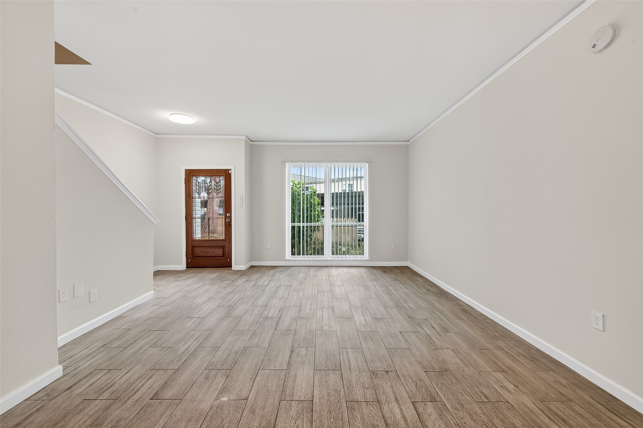 811 Threadneedle Street, Unit 258 Houston, TX 77079 - Photo 11 of 39 an empty room with wooden floor and windows