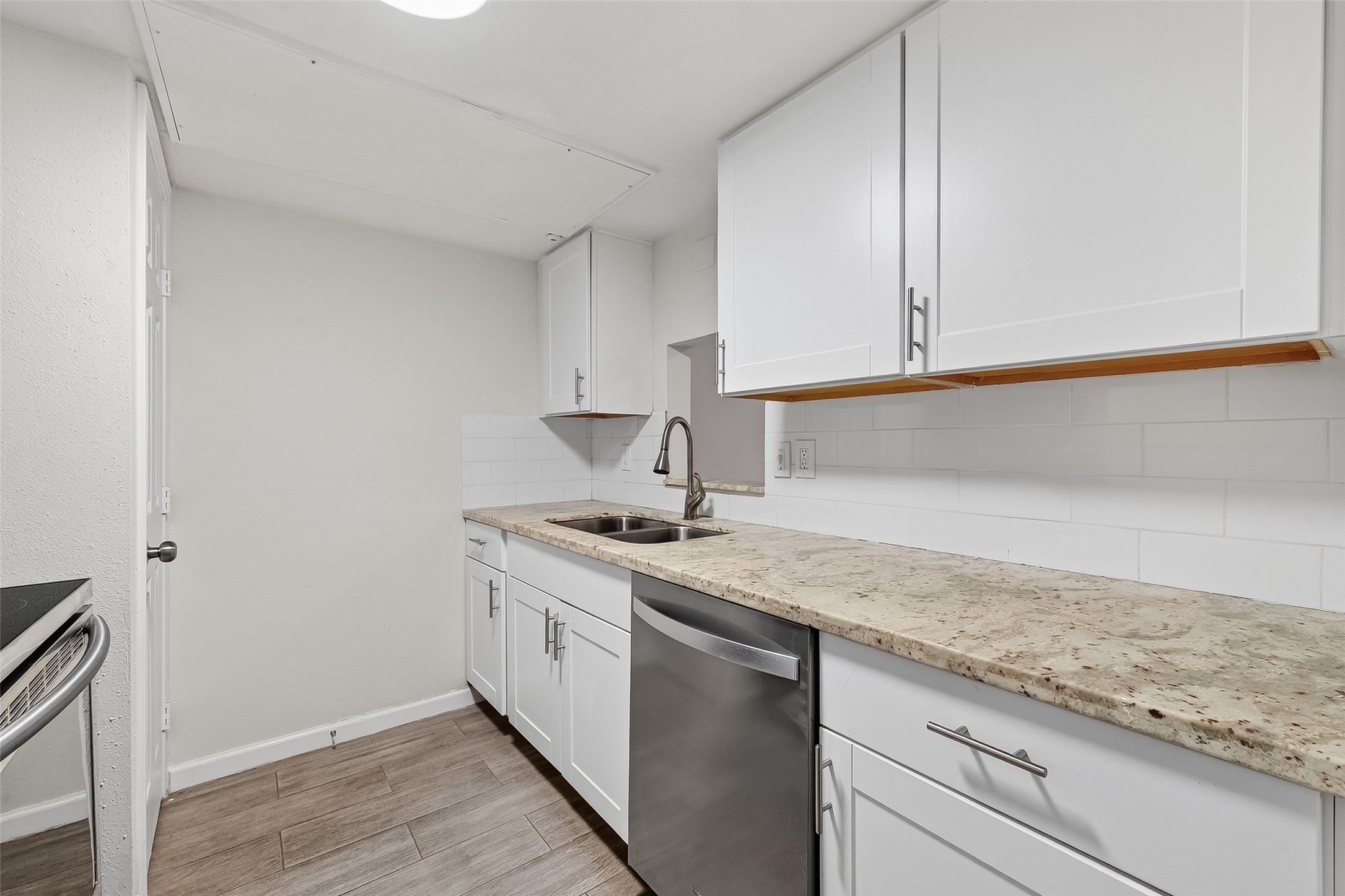 811 Threadneedle Street, Unit 258 Houston, TX 77079 - Photo 13 of 39 a kitchen with granite countertop white cabinets and a sink
