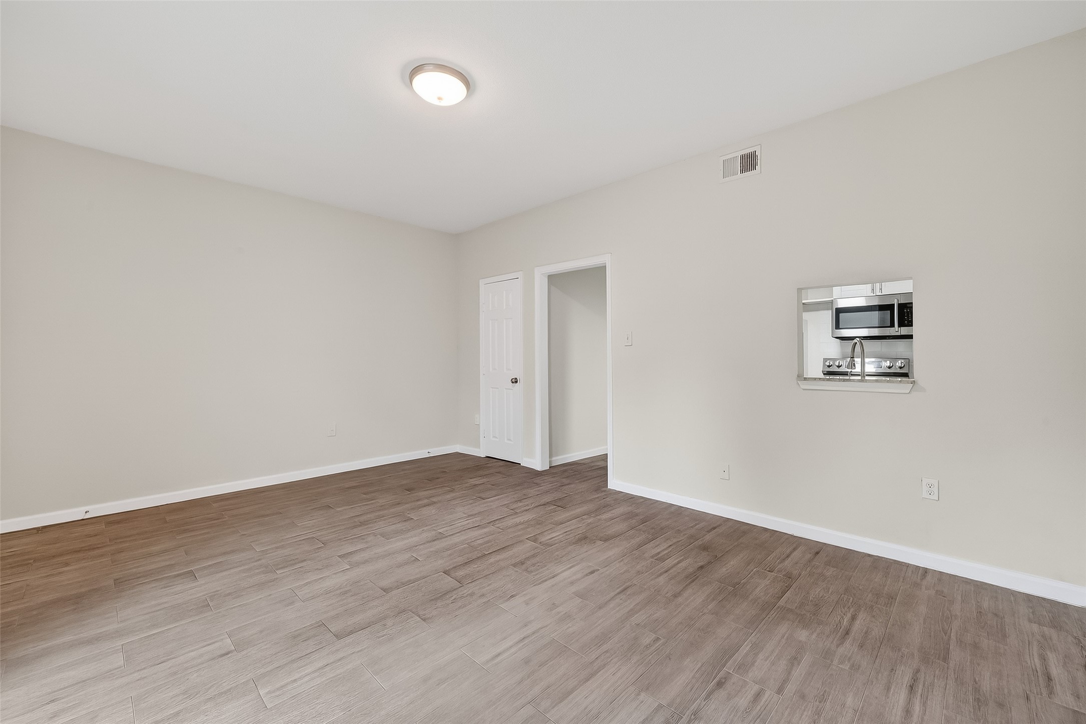 811 Threadneedle Street, Unit 258 Houston, TX 77079 - Photo 24 of 39 a view of an empty room with wooden floor