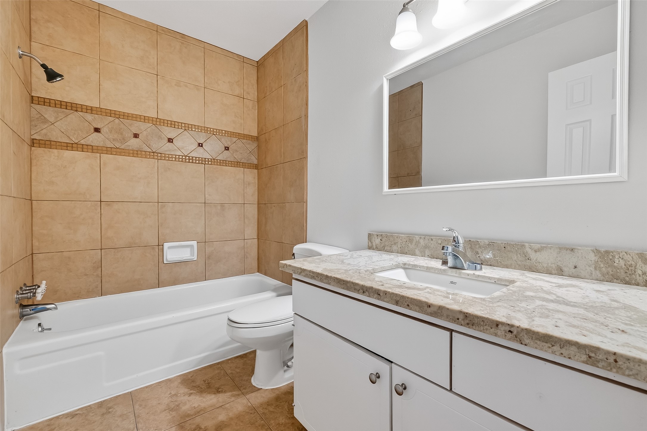 811 Threadneedle Street, Unit 258 Houston, TX 77079 - Photo 27 of 39 a bathroom with a granite countertop toilet a sink and bathtub